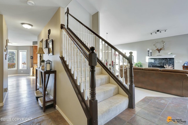 20420 Williamsburg Dr, Eagle River, AK 99577 - staircase with a high end fireplace and baseboards