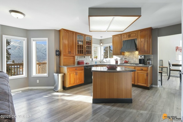 20420 Williamsburg Dr, Eagle River, AK 99577 - kitchen with black dishwasher, custom range hood, light wood-type flooring, and backsplash