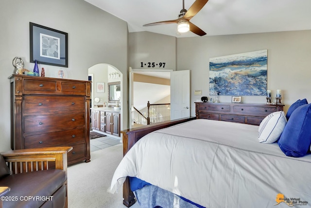 20420 Williamsburg Dr, Eagle River, AK 99577 - bedroom with arched walkways, ensuite bathroom, light carpet, and ceiling fan