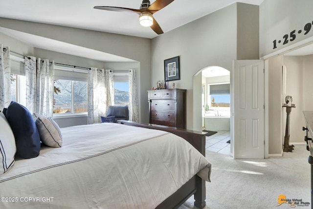 20420 Williamsburg Dr, Eagle River, AK 99577 - bedroom featuring arched walkways, carpet flooring, connected bathroom, baseboards, and a ceiling fan