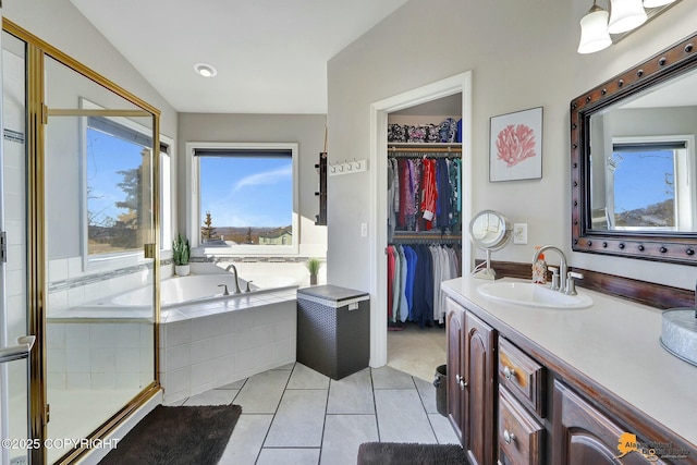 20420 Williamsburg Dr, Eagle River, AK 99577 - full bathroom with vanity, tile patterned flooring, a bath, a spacious closet, and a stall shower