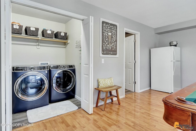 20420 Williamsburg Dr, Eagle River, AK 99577 - laundry area featuring washer and dryer, wood finished floors, and baseboards