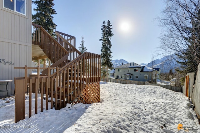 20420 Williamsburg Dr, Eagle River, AK 99577 - yard covered in snow featuring stairs and a deck with mountain view