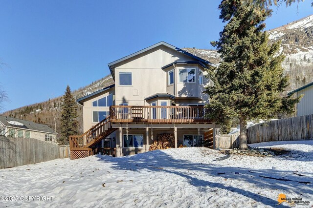 20420 Williamsburg Dr, Eagle River, AK 99577 - snow covered house with stairs and a wooden deck