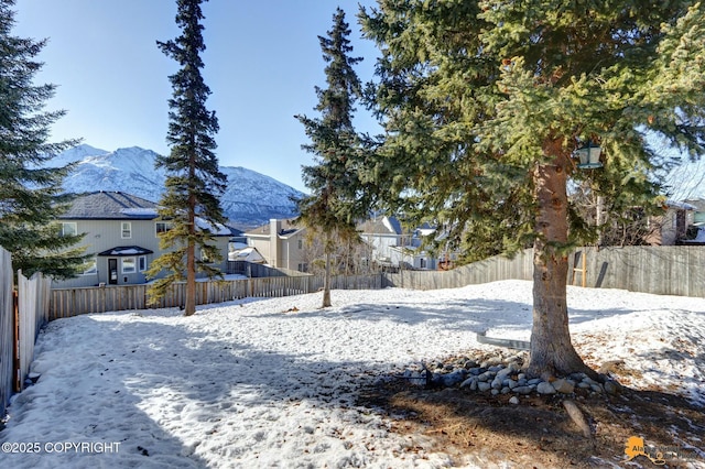 20420 Williamsburg Dr, Eagle River, AK 99577 - yard covered in snow with a residential view, a fenced backyard, and a mountain view