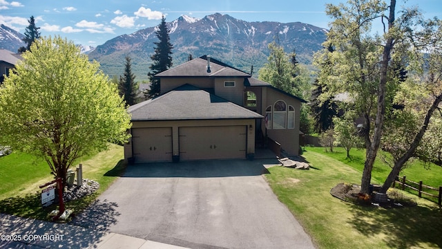20420 Williamsburg Dr, Eagle River, AK 99577 - view of front of home with a mountain view, an attached garage, and asphalt driveway