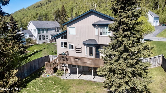 20420 Williamsburg Dr, Eagle River, AK 99577 - back of property with a deck, stairs, and a wooded view