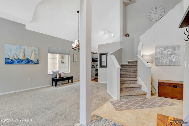 interior space featuring carpet, stairway, an inviting chandelier, high vaulted ceiling, and baseboards