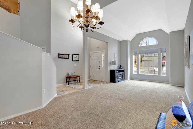 unfurnished living room featuring high vaulted ceiling, a notable chandelier, visible vents, baseboards, and carpet