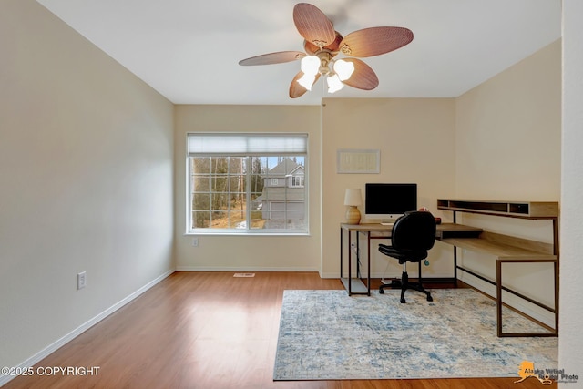 office area featuring wood finished floors, a ceiling fan, and baseboards