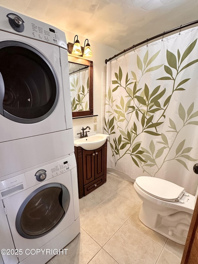 washroom featuring laundry area, light tile patterned flooring, a sink, and stacked washer and clothes dryer