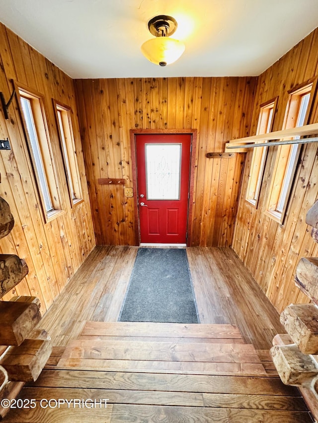 entryway with wood walls and hardwood / wood-style flooring