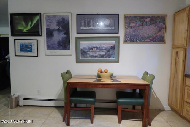 dining area featuring light tile patterned floors and baseboards