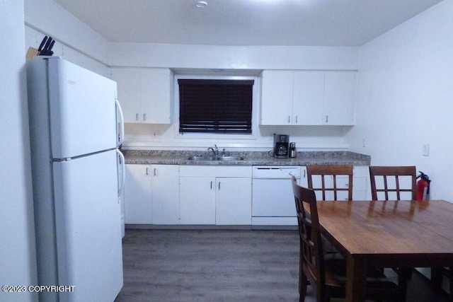 kitchen featuring white appliances, dark wood-style flooring, a sink, and white cabinetry