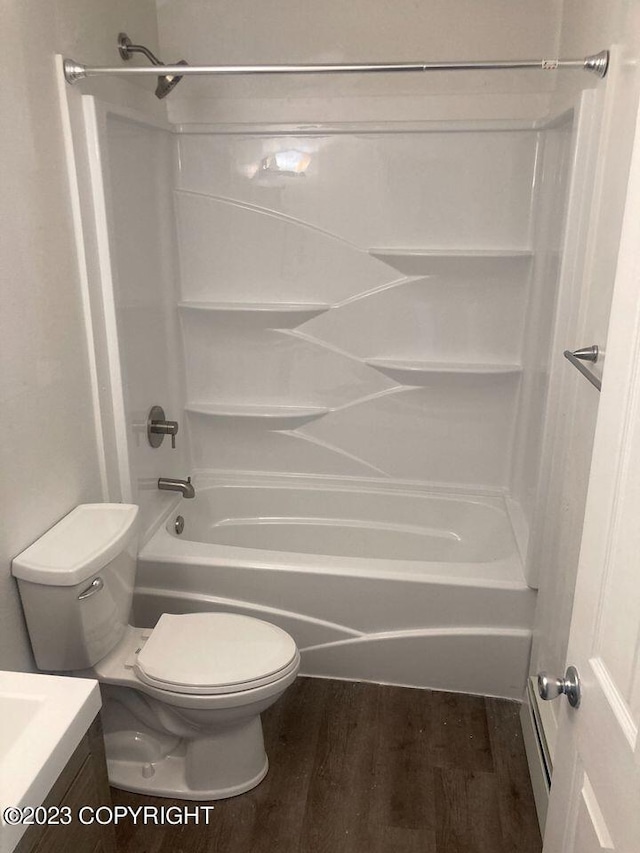 full bathroom featuring vanity,  shower combination, wood finished floors, and toilet