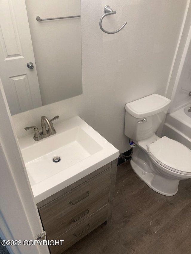 full bath featuring vanity, toilet, and wood finished floors