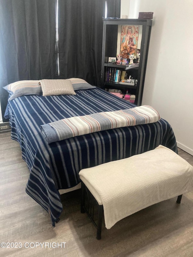 bedroom featuring wood finished floors