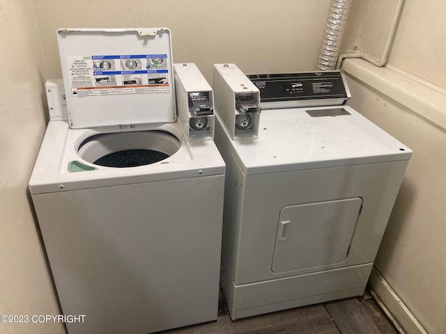 laundry area featuring separate washer and dryer and dark wood-type flooring