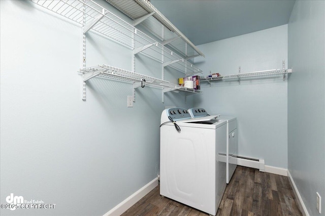 laundry room featuring washer and dryer, a baseboard radiator, baseboards, and laundry area