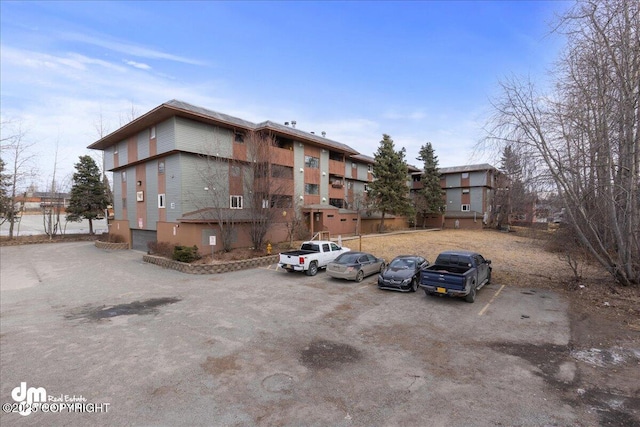 view of building exterior featuring uncovered parking