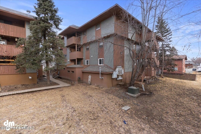 exterior space with brick siding and central air condition unit