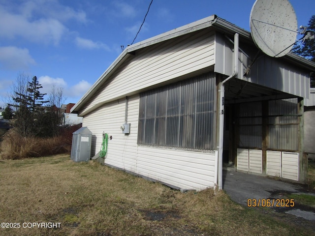 view of home's exterior featuring an outbuilding and a yard