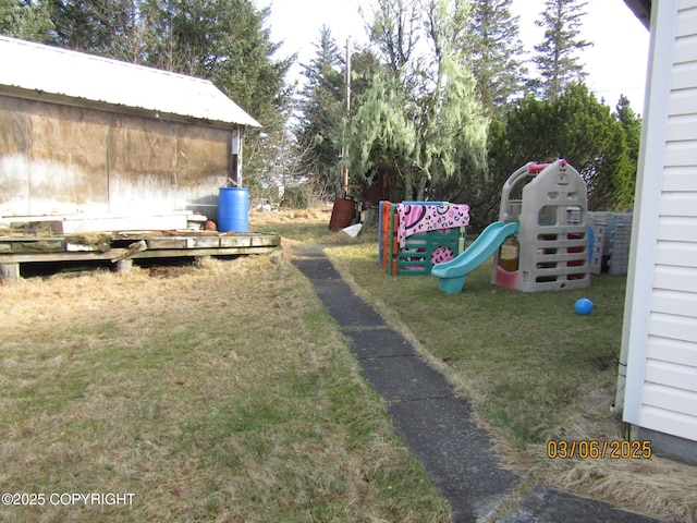 view of playground with a lawn