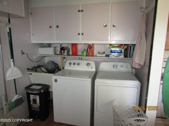 washroom with washing machine and dryer and cabinet space