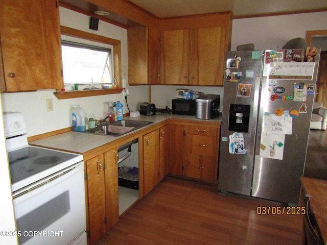 kitchen with white range with electric stovetop, light wood-style floors, black microwave, stainless steel refrigerator with ice dispenser, and a sink