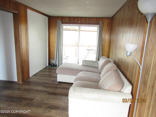 living room with wood finished floors and wooden walls