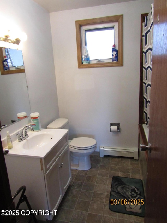 bathroom with toilet, baseboard heating, and vanity