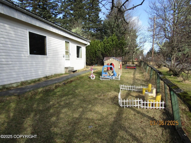 view of yard with an outdoor structure and fence