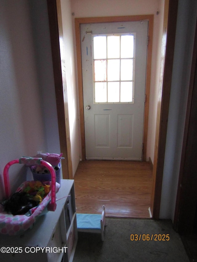 doorway to outside featuring wood finished floors