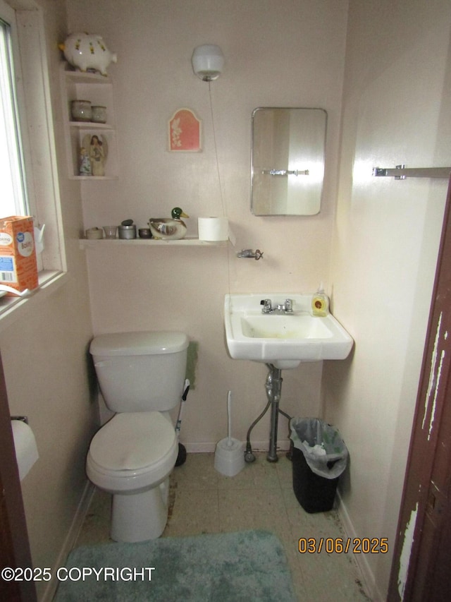 bathroom with tile patterned flooring, a sink, toilet, and baseboards