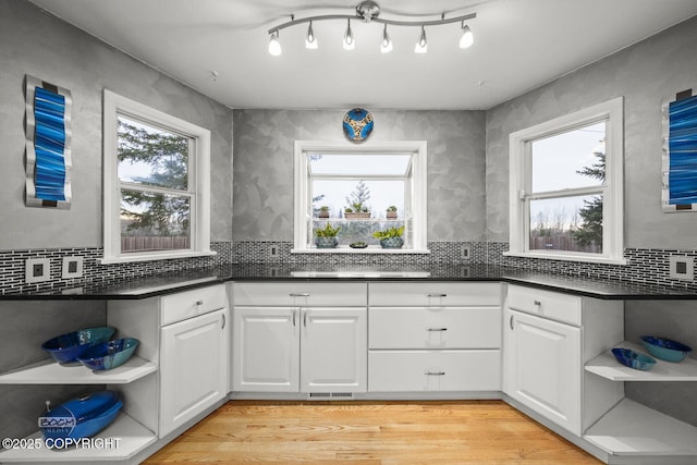 kitchen featuring open shelves and a healthy amount of sunlight