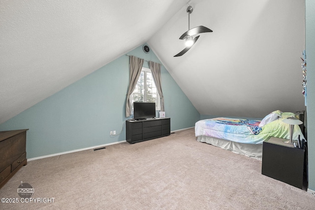 carpeted bedroom with vaulted ceiling, a ceiling fan, baseboards, and visible vents