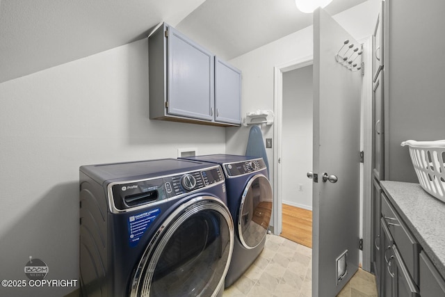 laundry room featuring separate washer and dryer and cabinet space