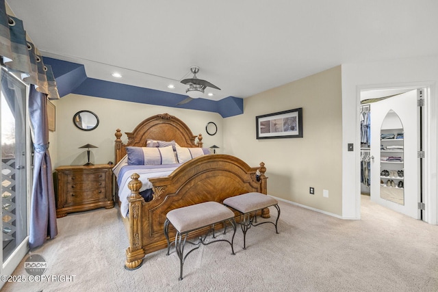 bedroom featuring carpet, baseboards, recessed lighting, ceiling fan, and a walk in closet