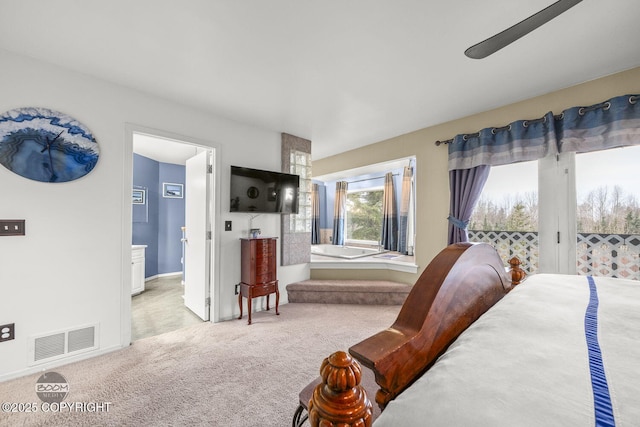 carpeted bedroom with ensuite bath, access to exterior, baseboards, and visible vents