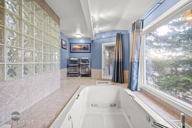 bathroom featuring a tub with jets