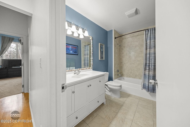 bathroom with tile patterned flooring, visible vents, toilet, shower / tub combo with curtain, and vanity