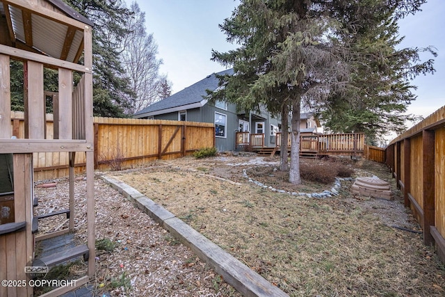 view of yard featuring a wooden deck and a fenced backyard