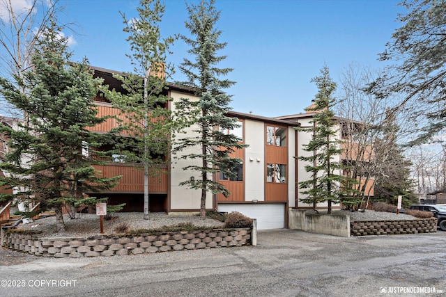 view of property featuring a garage and driveway