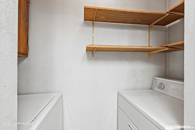 clothes washing area featuring laundry area and washing machine and dryer