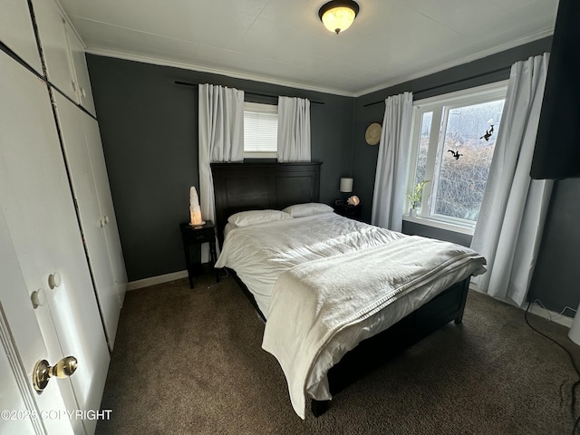 bedroom featuring crown molding, dark carpet, and baseboards