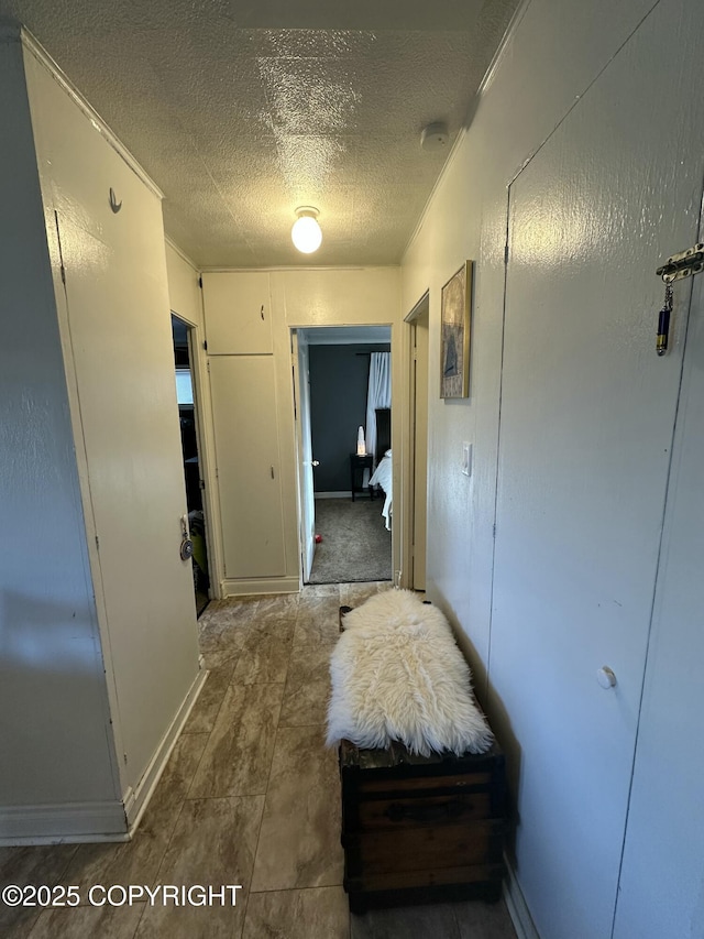 corridor featuring a textured ceiling