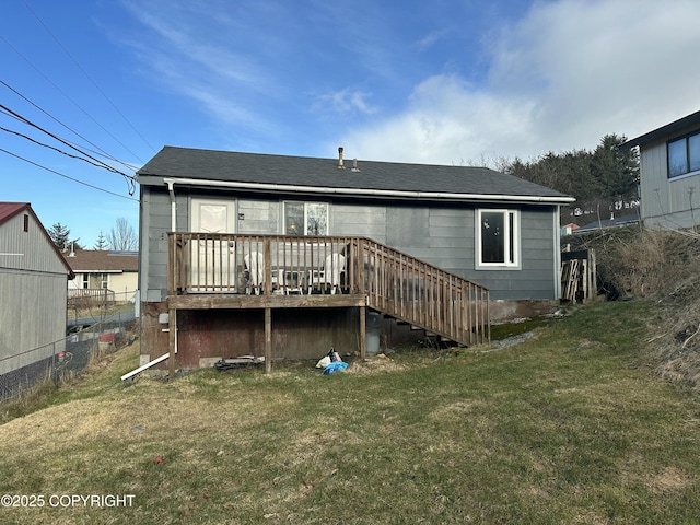 back of house featuring stairway, a lawn, a deck, and fence