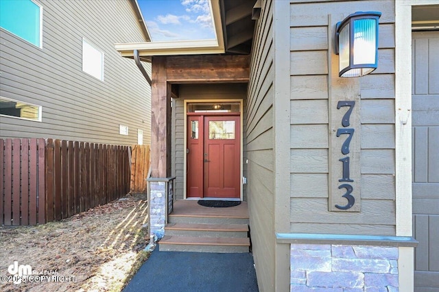 doorway to property with fence