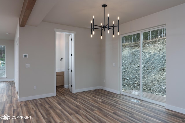 unfurnished dining area with baseboards, wood finished floors, and a healthy amount of sunlight