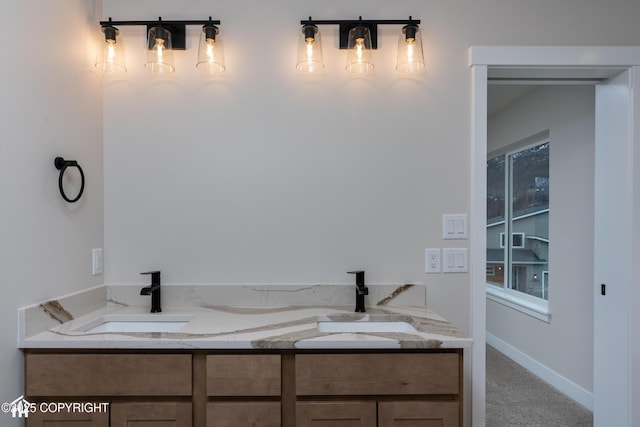 full bath with baseboards and a sink